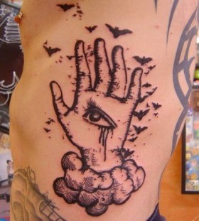 Birds, hand and eye tattoo on arm