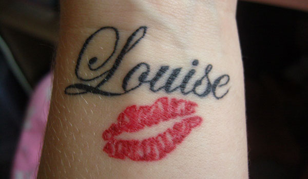 Black Louise lips tattoo on arm