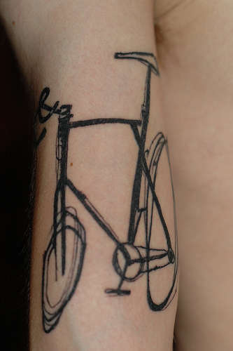 Black adorable bicycle tattoo on arm