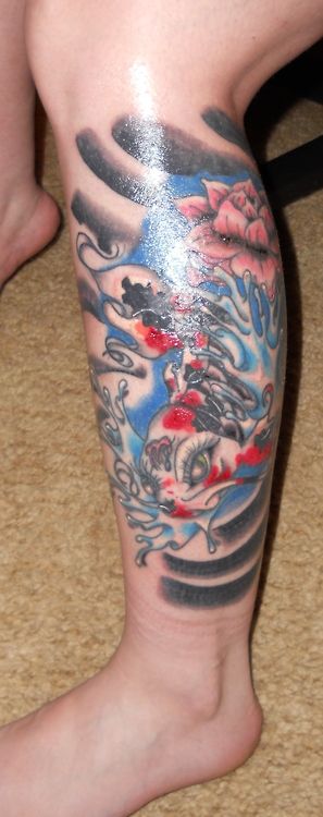 Black and blue fish tattoo on leg