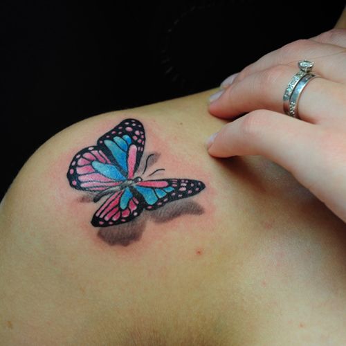 Black and red butterfly tattoo on shoulder