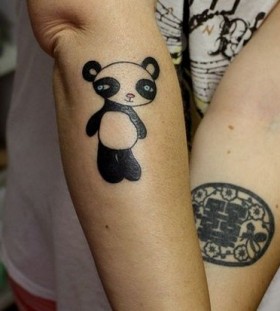 Black and white bear tattoo on arm