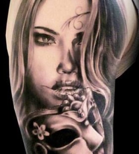 Black and white girl face tattoo on arm