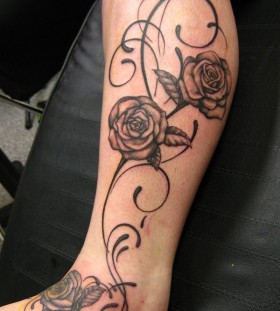 Black and white rose tattoo on leg