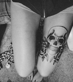 Black and white skull tattoo on leg