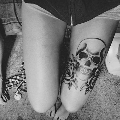 Black and white skull tattoo on leg