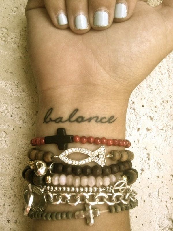 Black balance quote tattoo on arm