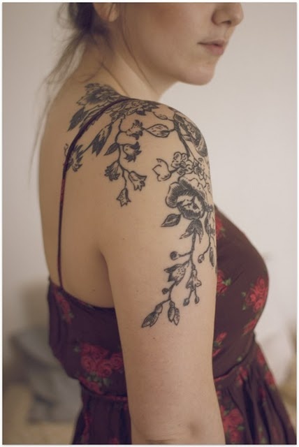 Black blossom cherry tattoo on arm