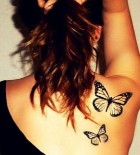 Black butterfly tattoo on shoulder