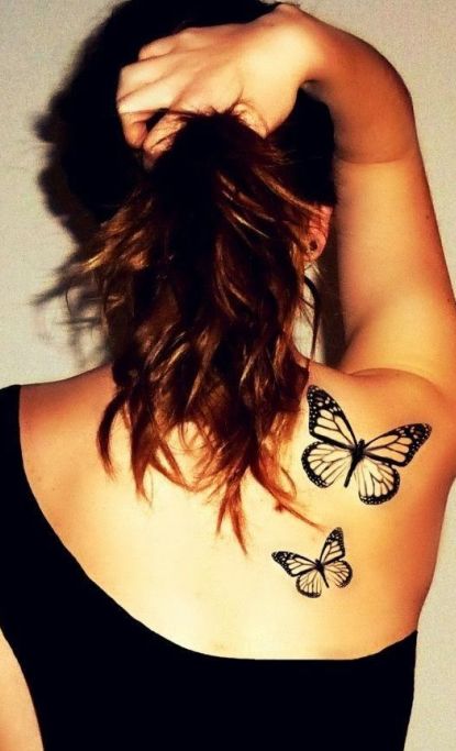 Black butterfly tattoo on shoulder