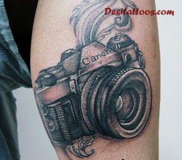 Black canon camera tattoo on leg