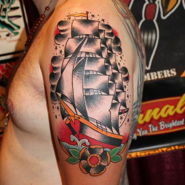 Black cute ship tattoo on arm