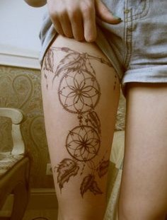 Black dream catcher tattoo on leg