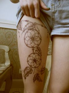 Black dream catcher tattoo on leg