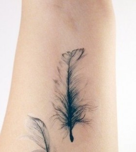 Black feather watercolor tattoo