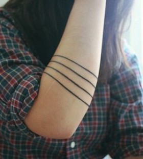 Black funny line tattoo on arm