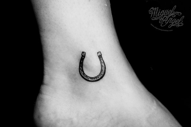 Black lovely horse shoe tattoo