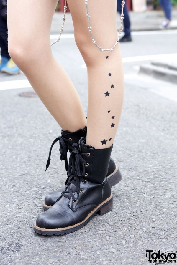 Black lovely star tattoo on leg