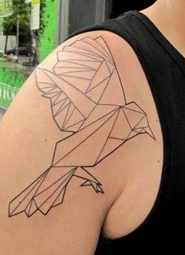 Black ornaments of origami tattoo on shoulder