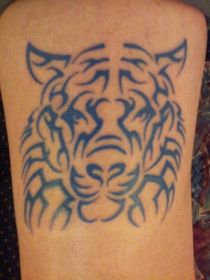 Black ornaments of tiger tattoo on leg