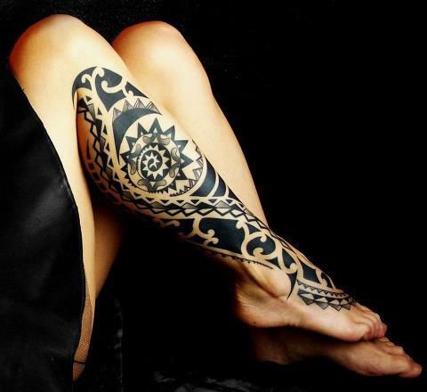 Black ornaments of tribal tattoo on leg