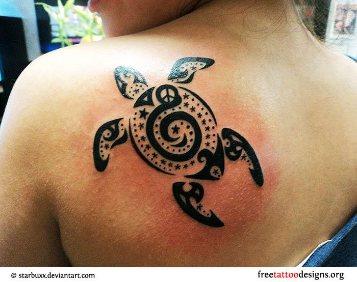 Black owal turtle tribal tattoo on shoulder