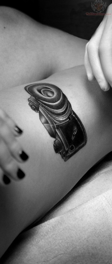 Black pretty camera tattoo on leg