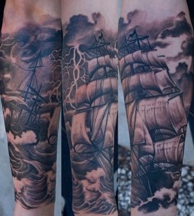 Black pretty ship tattoo on arm