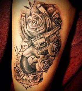 Black roses and gun tattoo