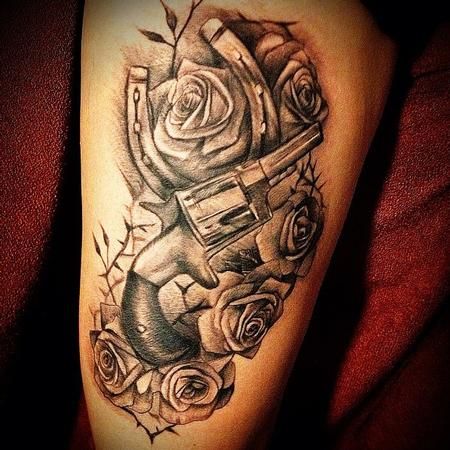 Black roses and gun tattoo