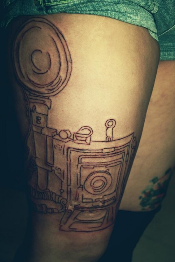 Black schemes of camera tattoo on arm