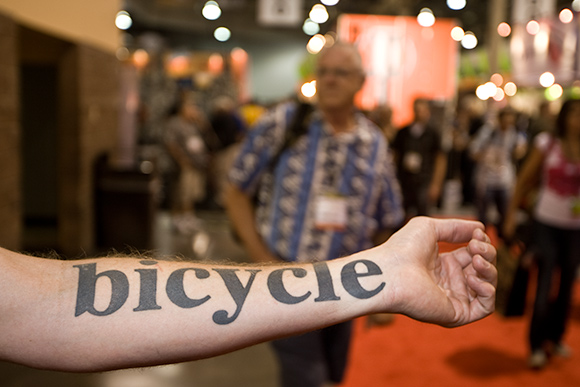 Black simple bicycle tattoo on arm