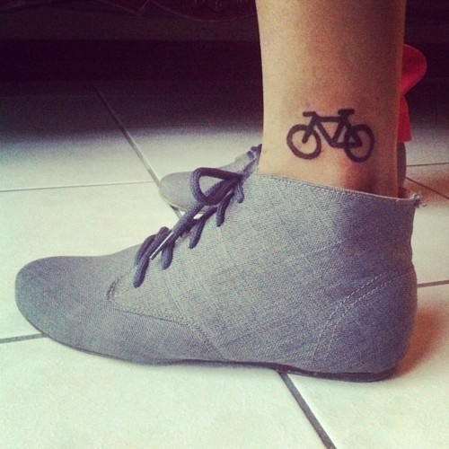 Black simple bike tattoo with shoes