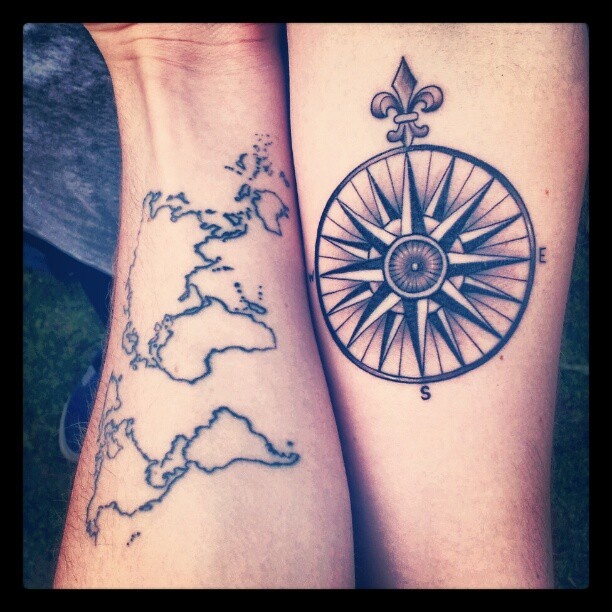 Black simple compass and map tattoo on arm