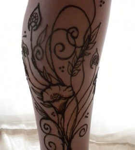 Black simple poppy tattoo on leg