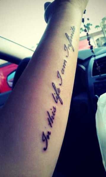 Black simple quote tattoo on arm