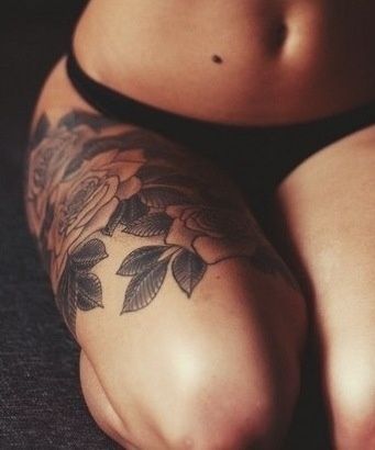 Black simple rose tattoo on leg