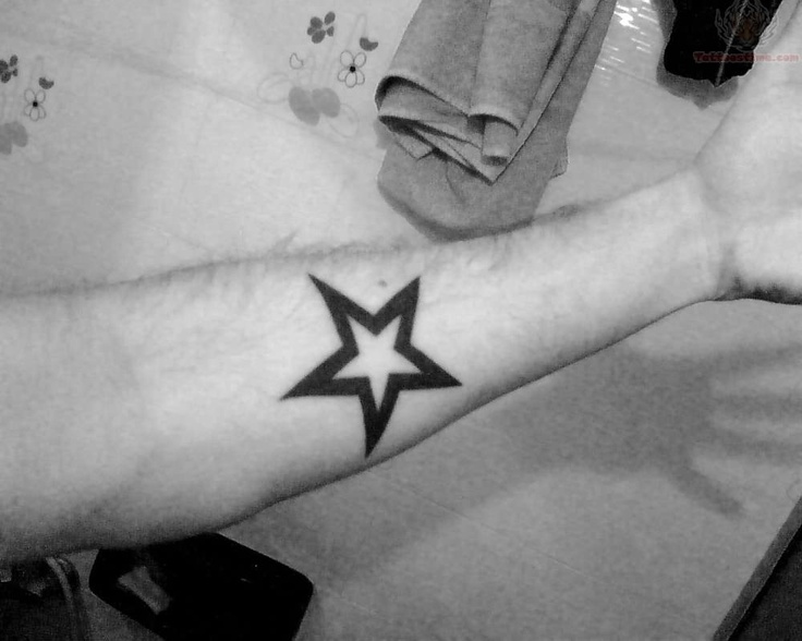 Black simple star tattoo on arm