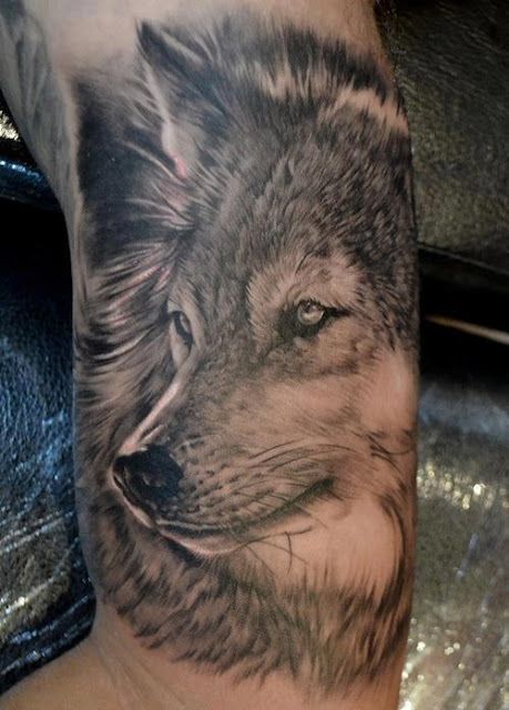 Black simple wolf tattoo on arm