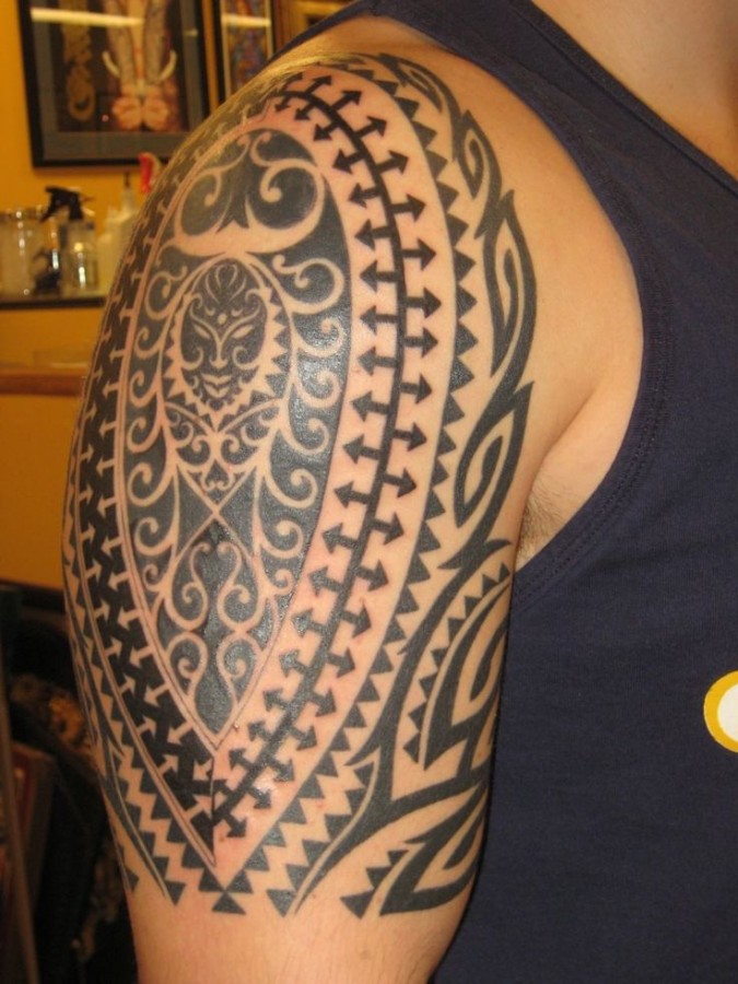 Black sun tribal tattoos on arm