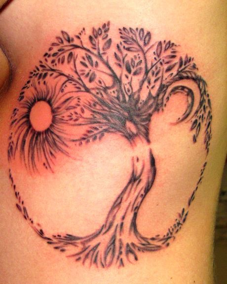 Black tree sun tattoo on leg