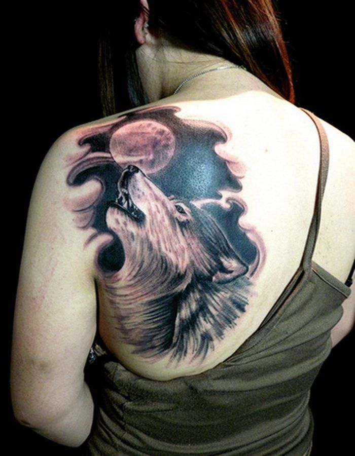 Black wolf and moon tattoo on shoulder