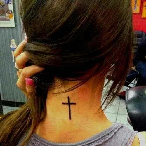 Black women’s back cross tattoo