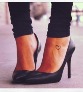 Black women's high-heels and heart tattoo