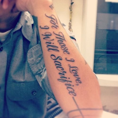 Black words quote tattoo on arm