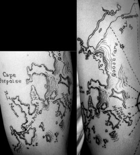 Black world map tattoo on legs