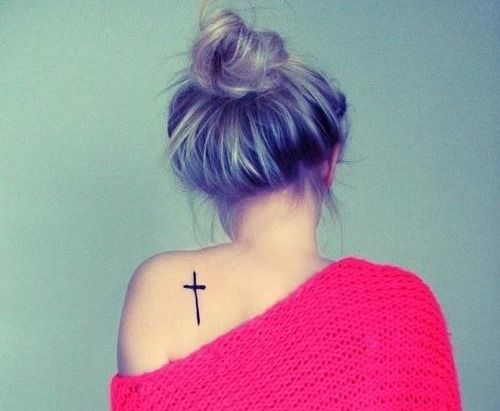 Blonde girl back cross tattoo