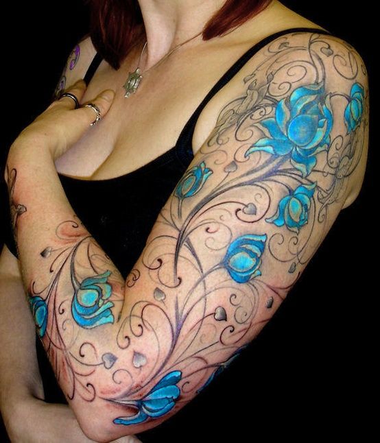 Blue and black flower tattoo on hand