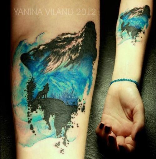 Blue and black wolf tattoo on arm