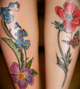 Blue and red poppy tattoo on leg